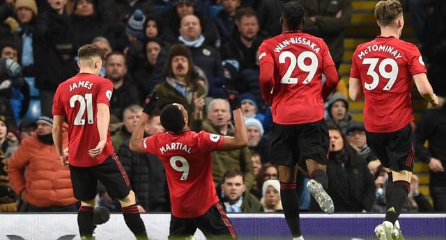 Manchester United's French striker Anthony Martial (2L) celebrates scoring their second goal during the English Premier League football match between Manchester City and Manchester United at the Etihad Stadium in Manchester, north west England, on December 7, 2019. (Photo by Oli SCARFF / AFP) / RESTRICTED TO EDITORIAL USE. No use with unauthorized audio, video, data, fixture lists, club/league logos or 'live' services. Online in-match use limited to 120 images. An additional 40 images may be used in extra time. No video emulation. Social media in-match use limited to 120 images. An additional 40 images may be used in extra time. No use in betting publications, games or single club/league/player publications. / 
