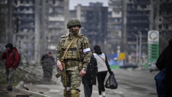 Un soldado ruso patrulla en una calle de Mariupol el 12 de abril de 2022. (Foto de Alexander NEMENOV / AFP)