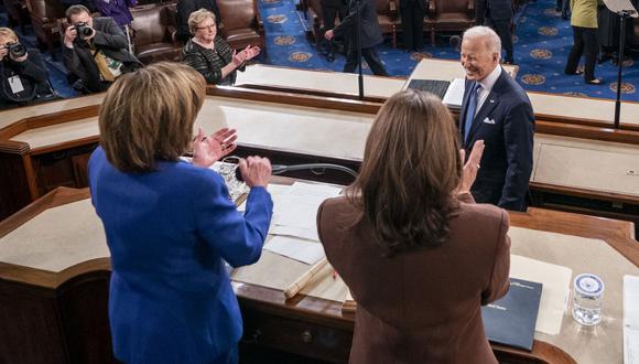 US President Joe Biden is applauded by US House Speaker Nancy Pelosi (D-CA) and US Vice President Kamala Harris as he delivers his first State of the Union address at the US Capitol in Washington, DC, on March 1, 2022. (Photo by SHAWN THEW / AFP)