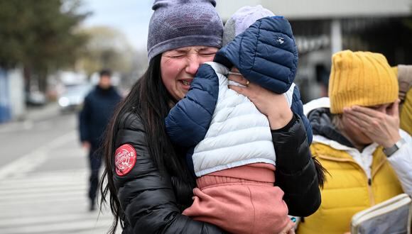 Una refugiada ucraniana que sostiene a su hijo llora después de llegar al cruce fronterizo de Siret entre Rumania y Ucrania el 18 de abril de 2022. (Foto de Daniel MIHAILESCU / AFP)