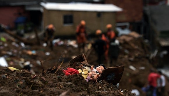 Una muñeca yace entre los escombros mientras los miembros del equipo de rescate de los servicios de bomberos buscan sobrevivientes después de un deslizamiento de tierra en Petrópolis, Brasil. (Foto: CARL DE SOUZA / AFP)