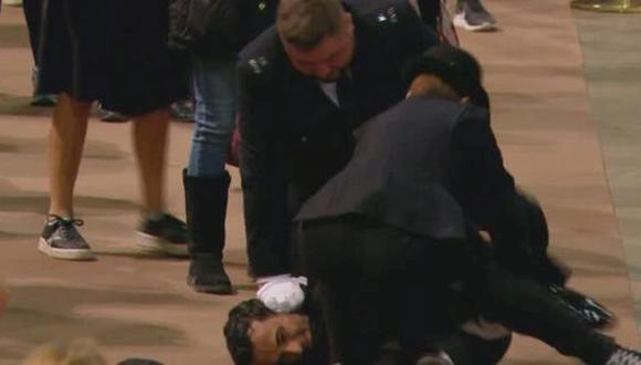 El hombre fue derribado y detenido después de intentar quitar la bandera sobre el ataúd de la reina Isabel II en Westminster Hall. (Foto: Captura de video)