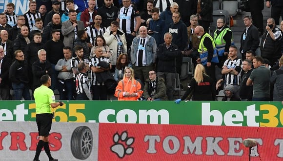 El árbitro inglés Andre Marriner detiene el juego poco antes del medio tiempo durante el partido entre Newcastle y Tottenham por una emergencia en la tribuna. (Foto: Paul ELLIS / AFP)