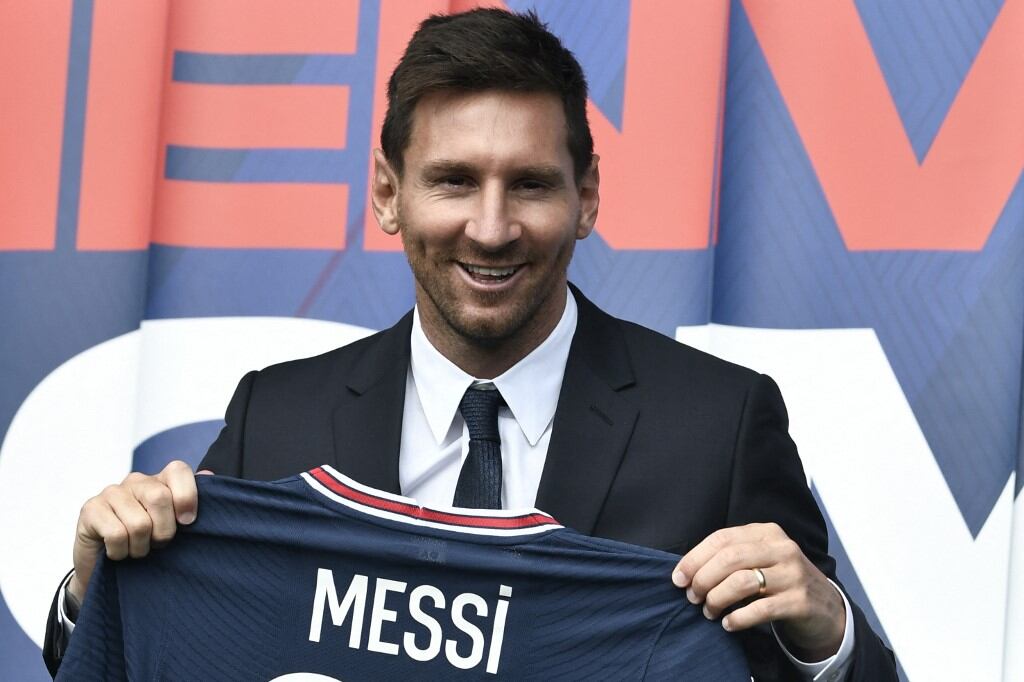 Argentinian football player Lionel Messi poses as he holds-up his number 30 shirt during a press conference at the French football club Paris Saint-Germain's (PSG) Parc des Princes stadium in Paris on August 11, 2021. - The 34-year-old superstar signed a two-year deal with PSG on August 10, 2021, with the option of an additional year, he will wear the number 30 in Paris, the number he had when he began his professional career at Spain's Barca football club. (Photo by STEPHANE DE SAKUTIN / AFP)