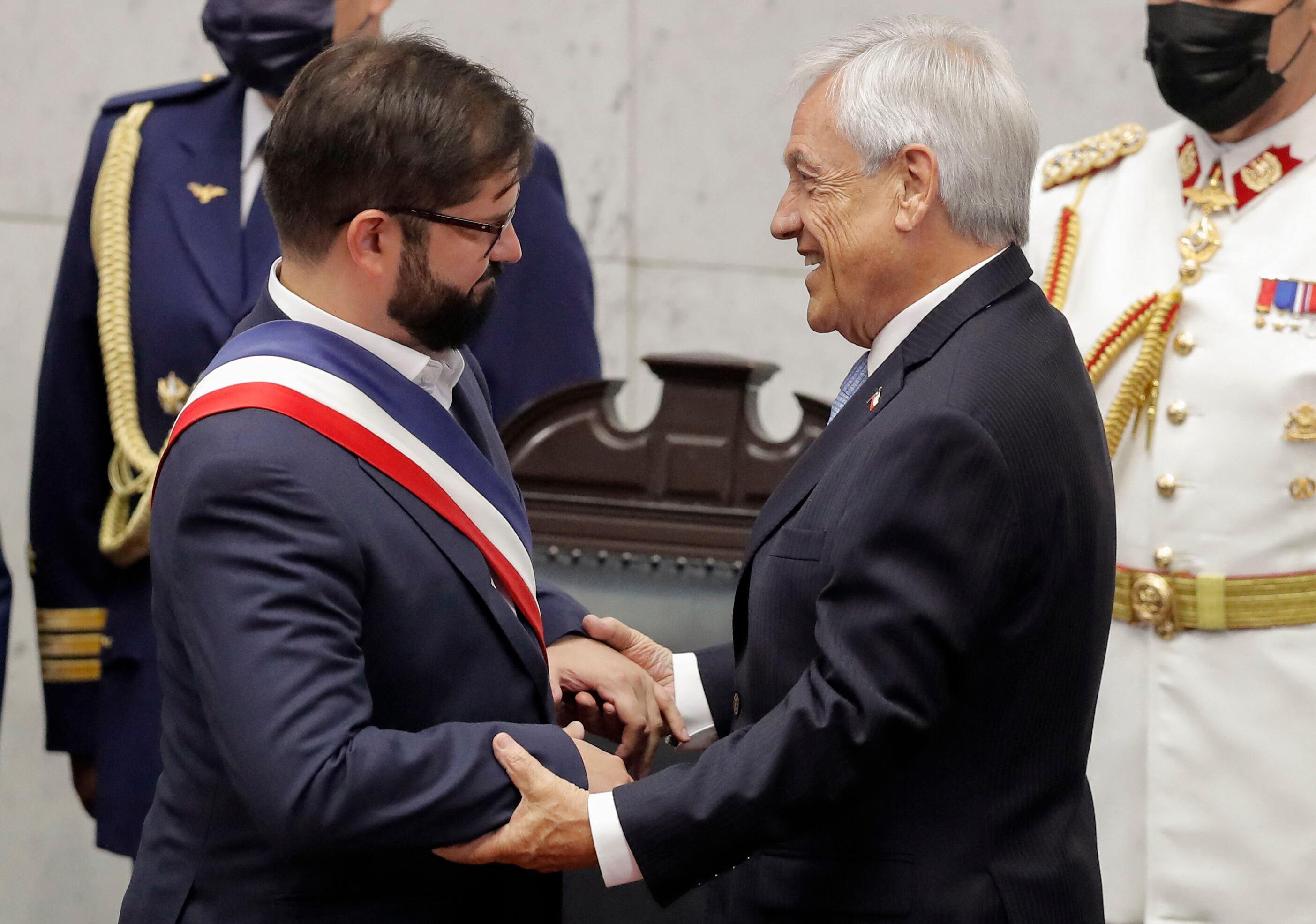 El presidente electo de Chile, Gabriel Boric (i), es recibido por el presidente saliente, Sebastián Piñera, durante su ceremonia de inauguración en el Congreso en Valparaíso, Chile, el 11 de marzo de 2022. (Foto de JAVIER TORRES/AFP)