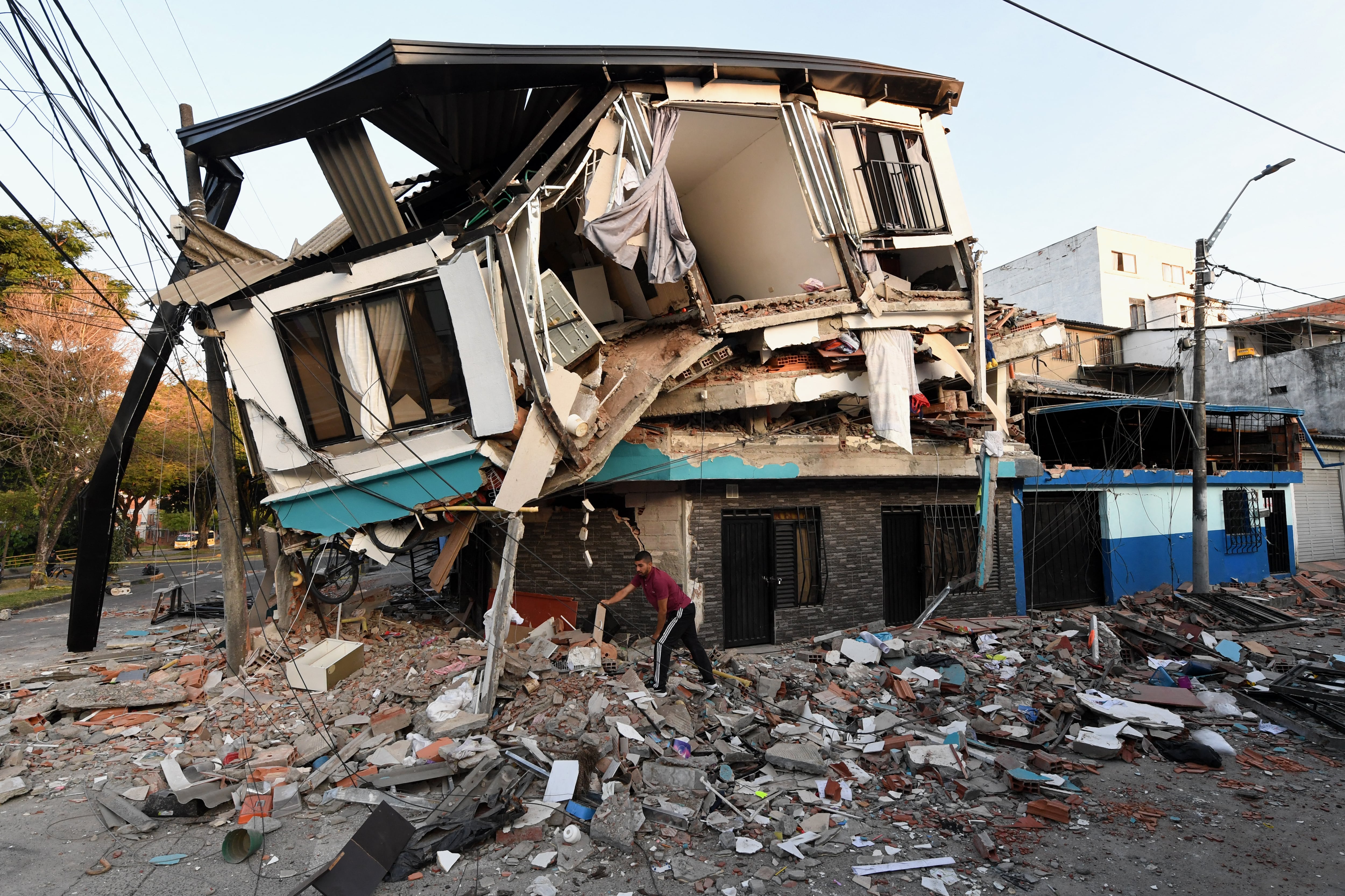 Un hombre retira los escombros de una casa derrumbada tras el terremoto que sacudió Pereira, Colombia, el 11 de agosto de 2026. (Foto de Jaime SALDARRIAGA / AFP).