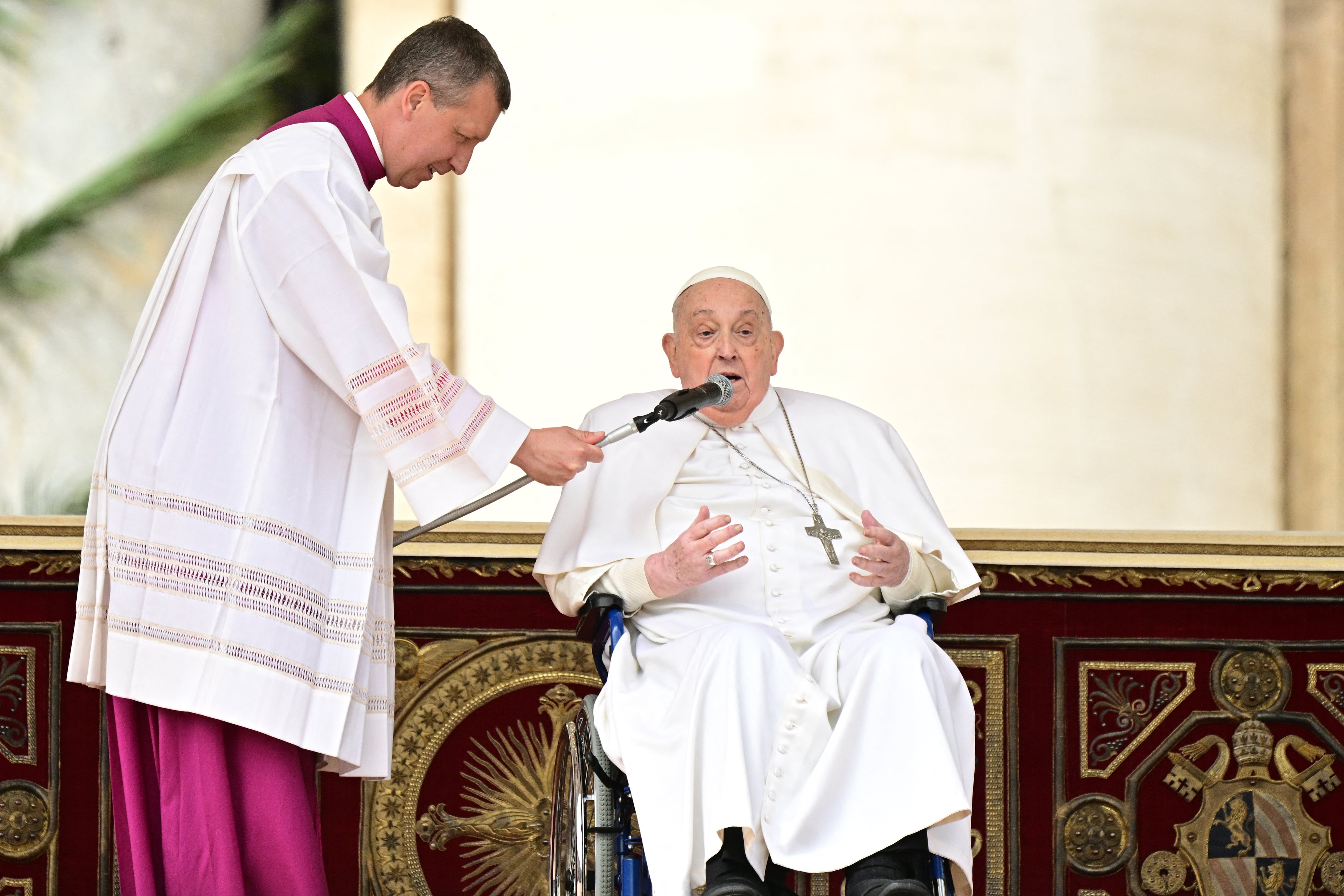 Pope Francis addresses the crowd during a surprise appearance at the end of the mass for Palm Sunday at St Peter's square in the Vatican on April 13, 2025. (Photo by Tiziana FABI / AFP)