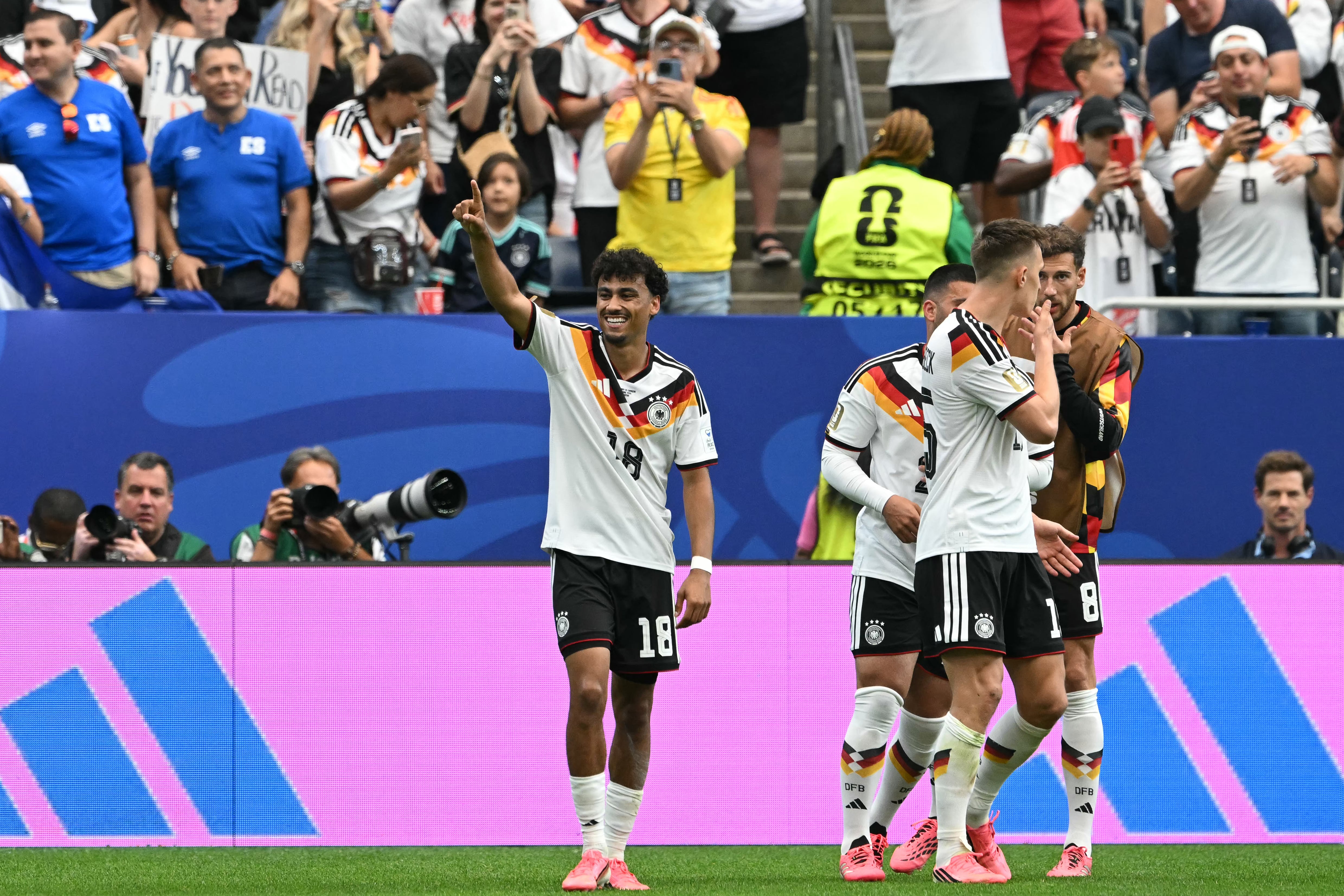 Germany's defender #18 Nathaniel Brown (L) celebrates with teammates after scoring his team's fifth goal during the 2026 World Cup Group E football match between Germany and Curacao at the Houston Stadium in Houston on June 14, 2026. (Photo by RONALDO SCHEMIDT / AFP)