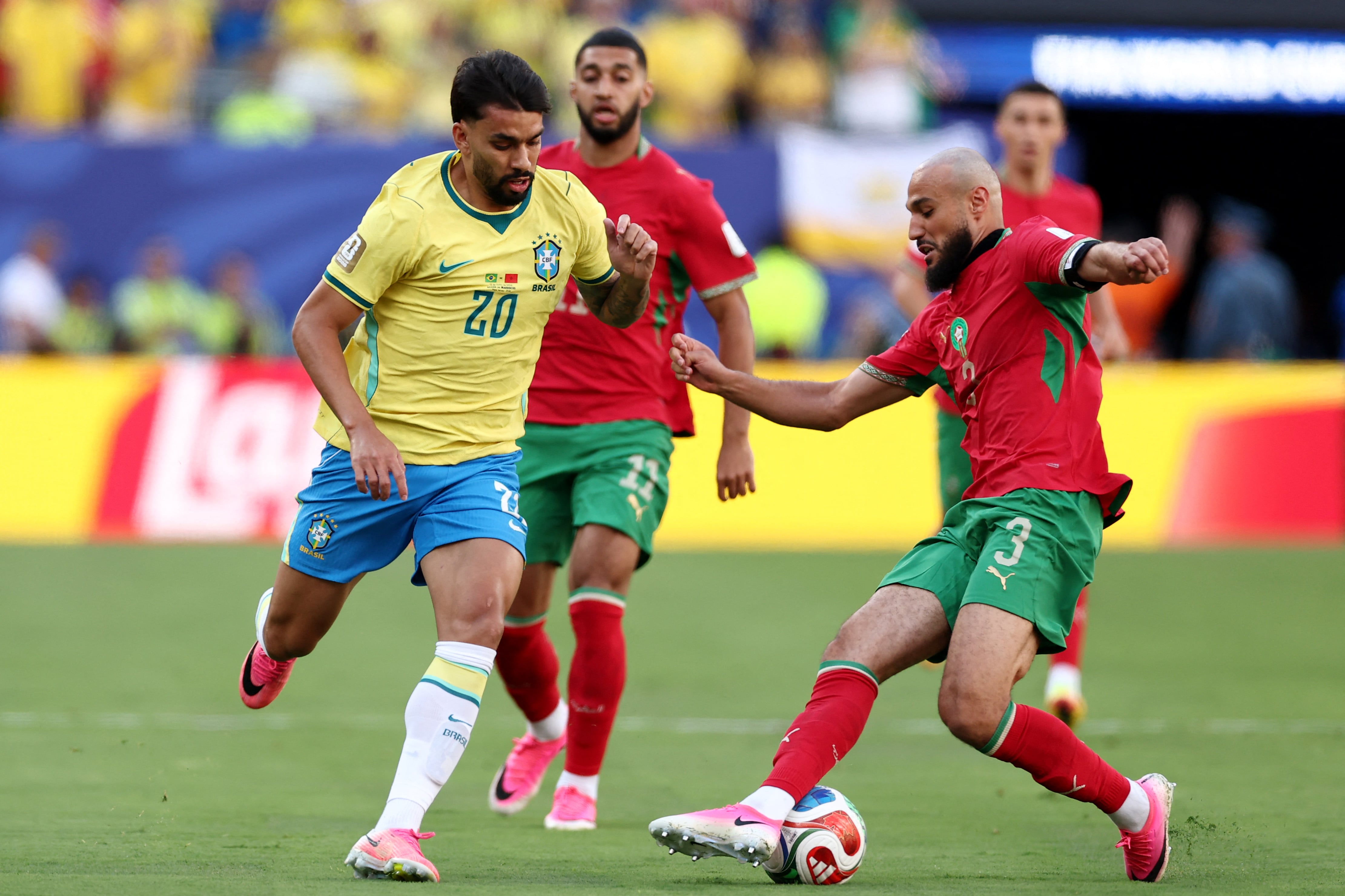 Brazil's midfielder #20 Lucas Paqueta and Morocco's defender #03 Noussair Mazraoui fight for the ball during the 2026 World Cup Group C football match between Brazil and Morocco at the New York/New Jersey Stadium in East Rutherford on June 13, 2026. (Photo by CHARLY TRIBALLEAU / AFP)