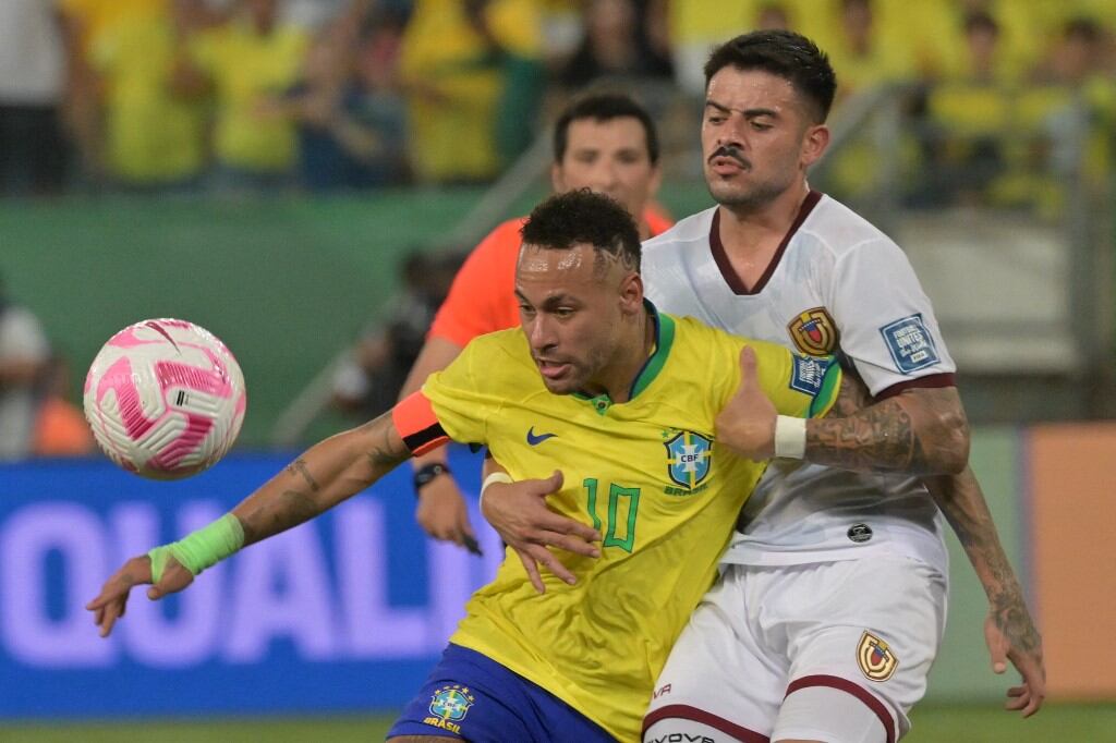 Brazil's forward Neymar (L) and Venezuela's midfielder Junior Moreno vie for the ball during the 2026 FIFA World Cup South American qualification football match between Brazil and Venezuela at the Arena Pantanal stadium in Cuiaba, Mato Grosso State, Brazil, on October 12, 2023. (Photo by NELSON ALMEIDA / AFP)
